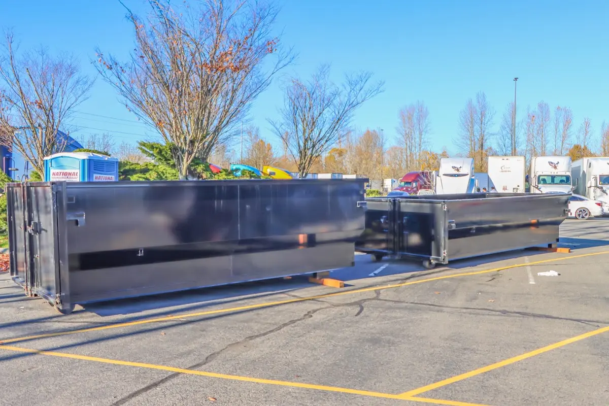 Professional dumpster rental service with roll-off container on residential driveway in Town 'n' Country